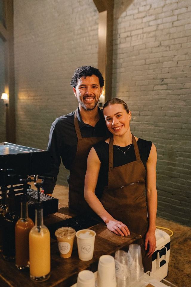 Two Brew Collective baristas behind the coffee bar