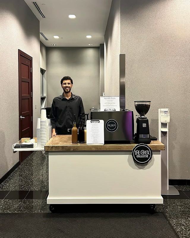 Barista at The Brew Collective cart in an office lobby